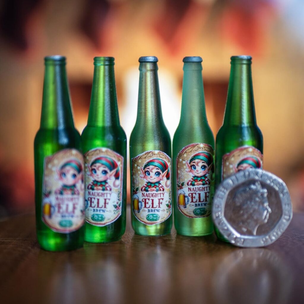 Five Naughty Elf Brew miniature bottles next to a 20p coin