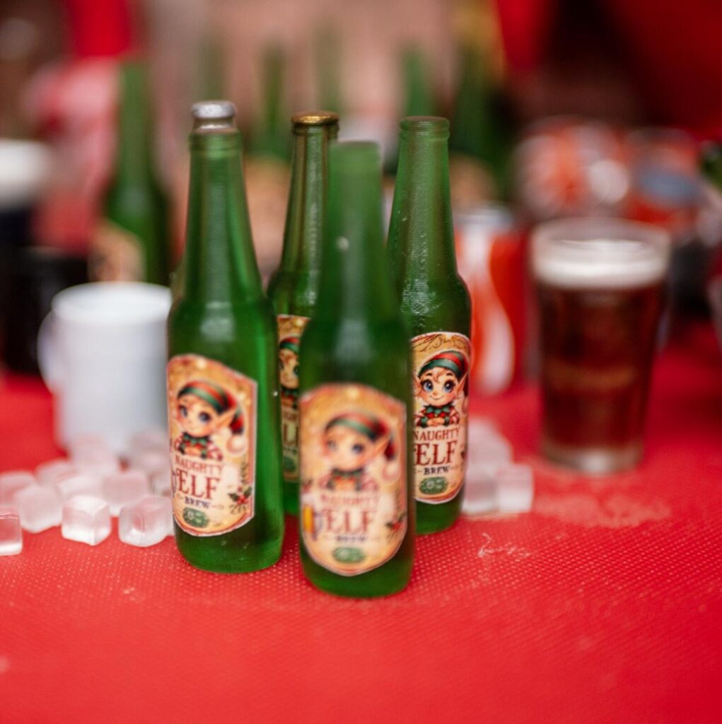 Naughty Elf Brew bottles with a mini pint and ice cubes