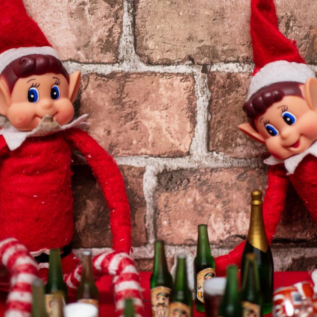 Two elves surrounded by miniature bottles
